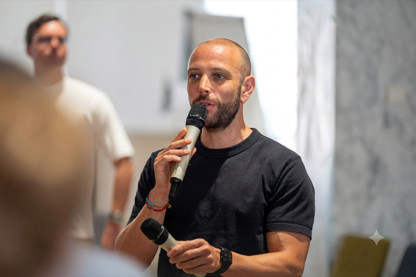 Alex speaking into a microphone at a King's Digital Futures Institute event